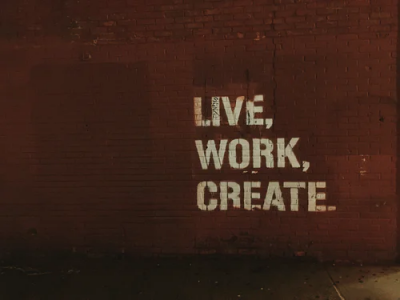 live work create spray painted on brick