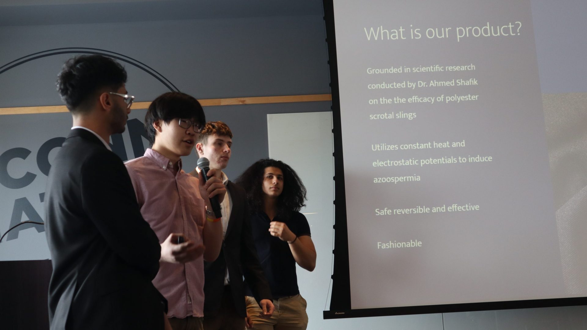 Students presenting in front of their slides at HackUConn 2023